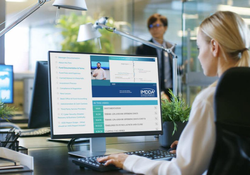 In the Office Businesswoman at Her Desk, She's Using Personal Computer with Statistical Information Showing on It's Screen. Her Colleague Enters Office.