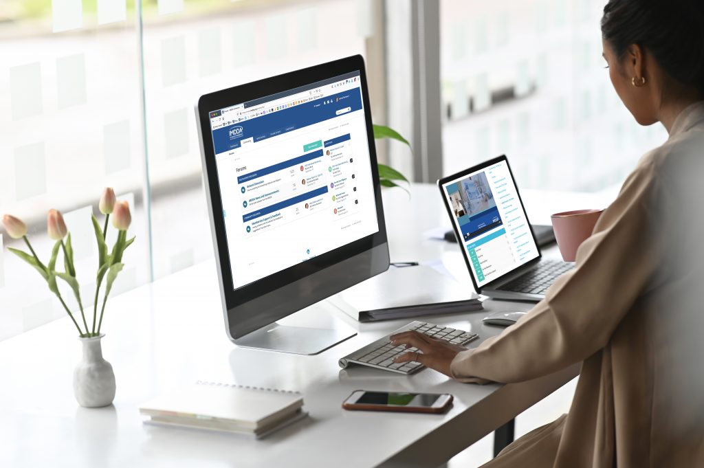 Two screen of computer with businesswoman typing her computer keyboard on modern office desk.